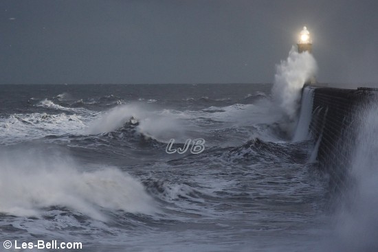 Waves breaking over Tynemouth Lighthouse, River Tyne North Pier.