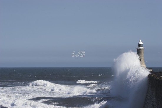 Waves breaking over Tynemouth Lighthouse, River Tyne North Pier.